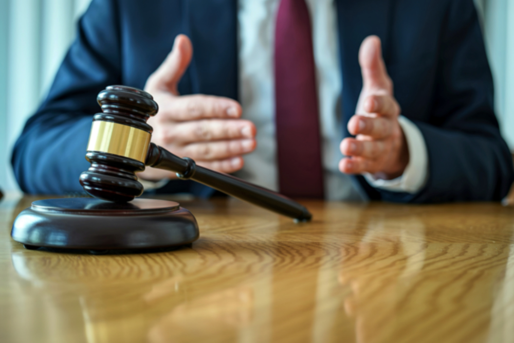 Attorney explaining legal documents with a gavel on the desk during a discussion about representing a business in court.