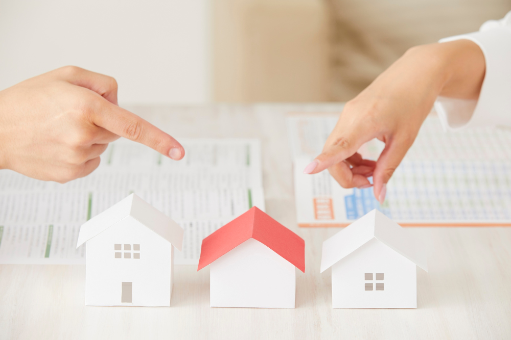 Two people pointing toward one house among several options while discussing property involved in probating an estate without a will.