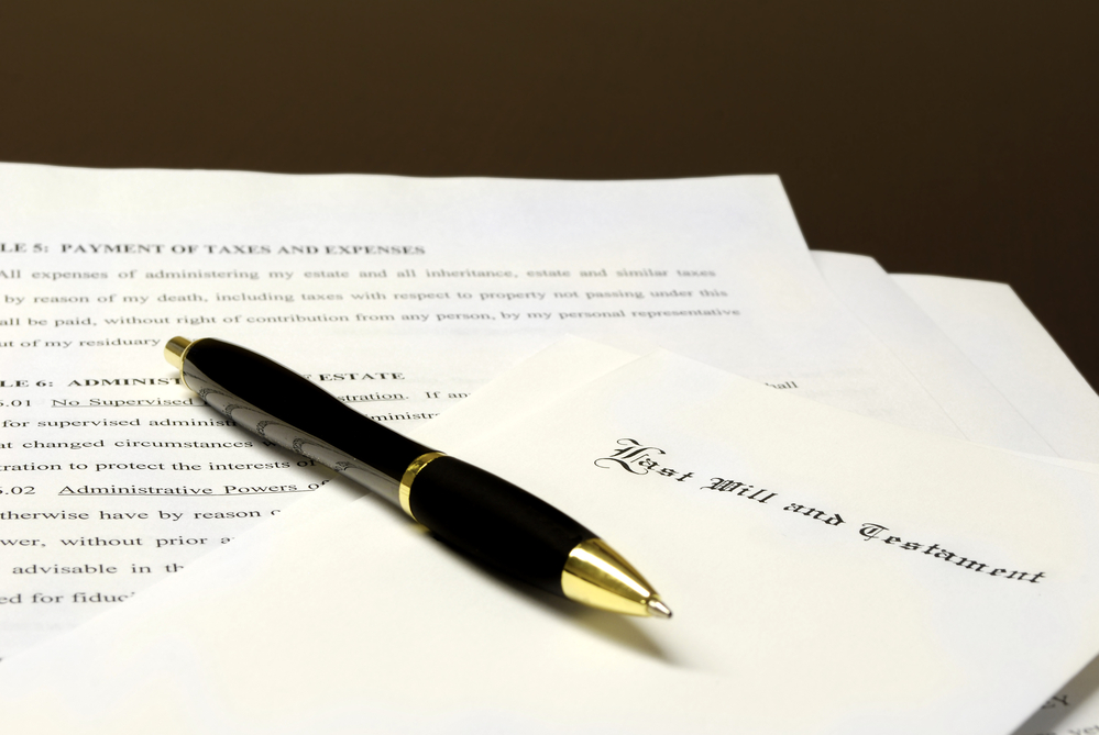 Wills Vs. Living Trusts - Pen laying on top of a Will for estate planning