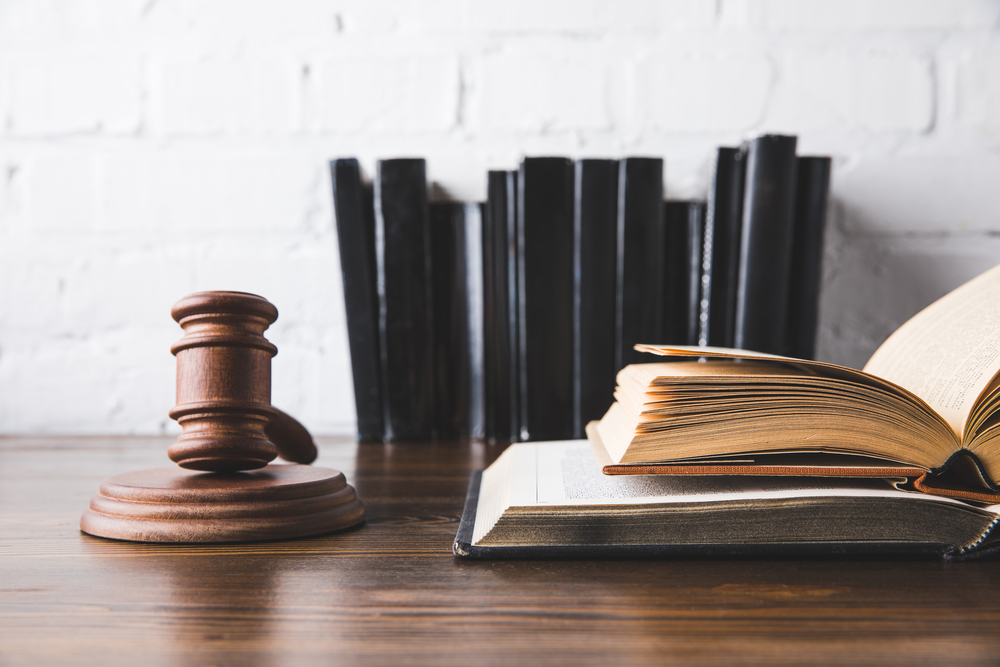 Choosing the Right Real Estate Litigation Lawyer - legal books and wooden gavel